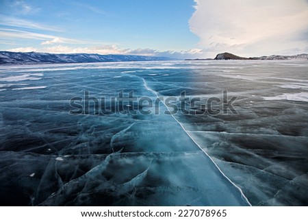 Winter baikal. Ice field and mountain on background