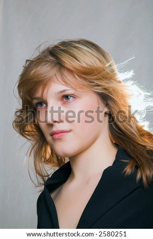 portrait of young woman in black coat (back lighting)