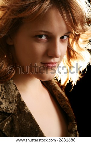 portrait of woman with flying hair and back lighting