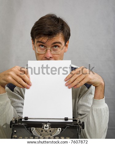 man with typewriter thinking about new novel