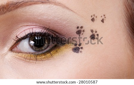 woman\'s eye with cat footprint on face