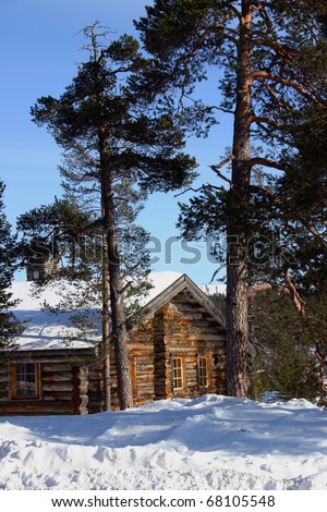 Winter cabin with snow