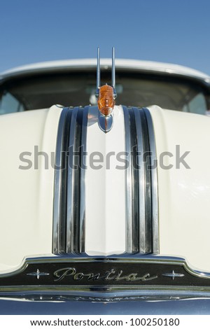 FARNBOROUGH, UK - APRIL 6: Hood ornament closeup of a vintage Pontiac Chieftain on display at the annual Wheels Day auto and bike show on April 6, 2012 in Farnborough, UK