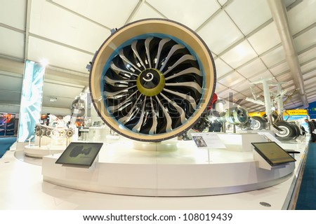 FARNBOROUGH, UK - JULY 12: Exhibition stands displaying large jet engines and other components used in the aviation industry at the Farnborough International Airshow, UK on July 12, 2012