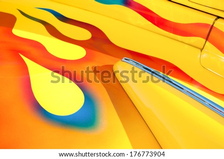 vehicle panel abstract with vivid yellow and flame metallic body paintwork