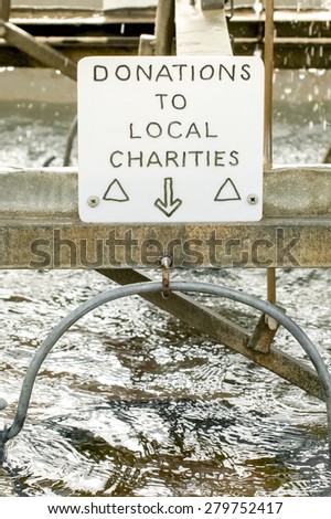 donation sign above a charity wishing well
