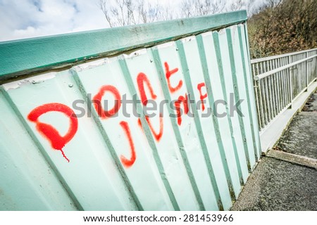don\'t jump graffiti warning on a bridge