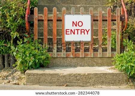 no entry sign on a weathered gate