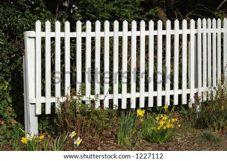 White picket fence and flower bed.