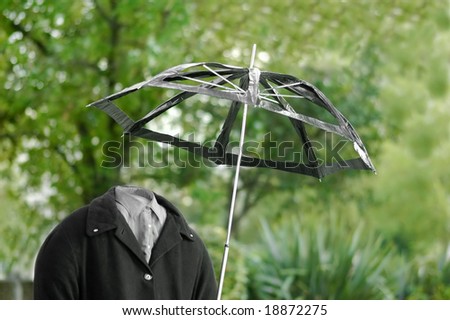 invisible man out for a walk in the rain with a useless umbrella