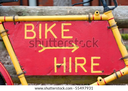 bike hire sign on a battered and peeling frame