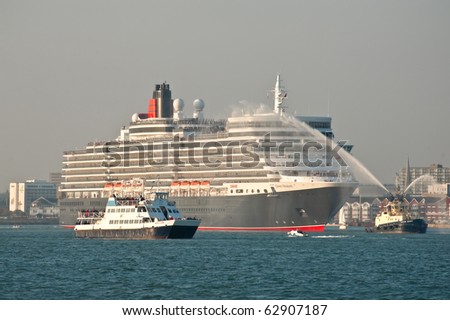 SOUTHAMPTON, UK - OCT 12: A hazy sunset departure from port for the Queen Elizabeth cruise liner on her maiden voyage. Oct 12, 2010, Southampton, UK.