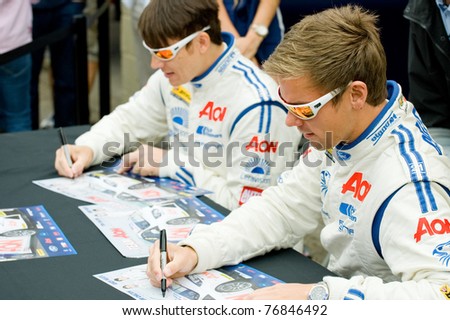 THRUXTON, UNITED KINGDOM - MAY 1: Team Aon drivers Tom Chilton and Andy Neate sign autographs at the British Touring Car Championship on May 1, 2011 in Thruxton, UK.