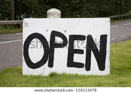 Hand Painted Open Sign next to Road
