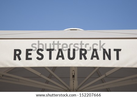Restaurant Sign against Blue Sky