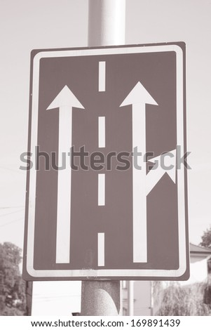 Blue Arrow Traffic Direction Sign on Blue Sky Background