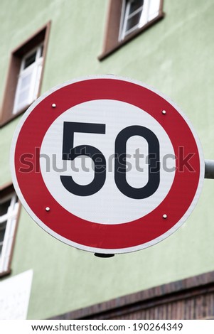 Red Fifty Speed Sign in Urban Setting