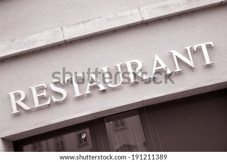 Silver Restaurant Sign on Wall Background