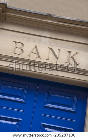 Closeup of Bank Sign on Yellow Stone Background
