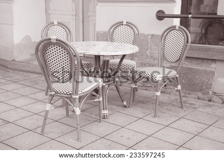 Cafe Table and Chairs in Paris Street in Black and White Sepia Tone