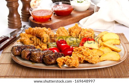 Mixed grilled and fried  meat platter and pickles