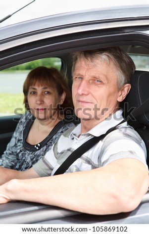 Close up of senior Caucasian couple sitting in domestic car and smiling