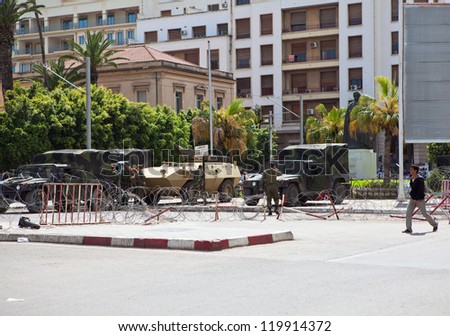 TUNIS CITY, TUNISIA - CIRCA MAY, 2012: Military guards with guns in war car standing before administration building on circa May, 2012 in Tunis city, Tunisia, Africa. Protection of important sites