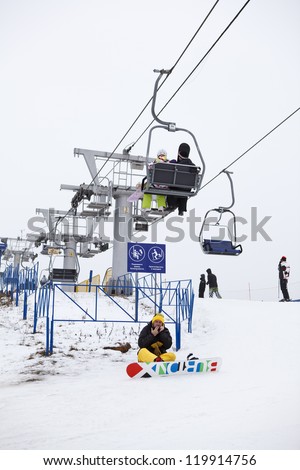 DMITROV, MOSCOW REGION, RUSSIA - JANUARY 6: Ski lift and and unidentified man under it on January 6, 2012 in Dmitrov, Moscow Region, Russia. Russian popular ski resorts \