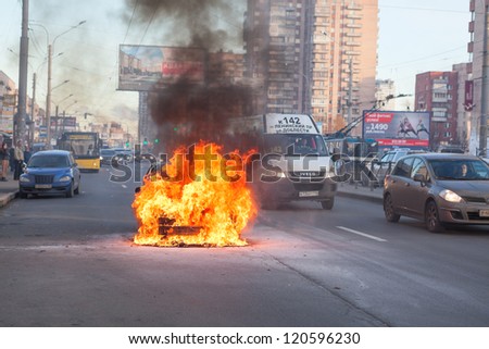 SAINT-PETERSBURG, RUSSIA-NOVEMBER 11: Burning car is on city road on November 11, 2012 in Saint-Petersburg, Russia. Self-ignition car wiring. No one was injured.