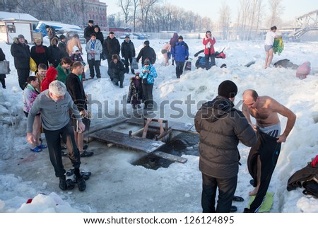 SAINT-PETERSBURG, RUSSIA-JANUARY 19: People in ice-hole dip three times in Epiphany celebration on January 19, 2013 in Saint-Petersburg, Russia.  Orthodox tradition in Epiphany (Holy Baptism)