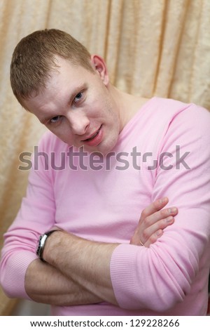 Portrait of Caucasian handsome blond hair man in pink t-shirt