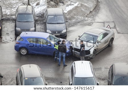 SAINT-PETERSBURG, RUSSIA - CIRCA MARCH, 2013: Drivers during cars accident and police officer talk about registration and paperwork on circa March, 2013 in Saint-Petersburg, Russia. No one was injured