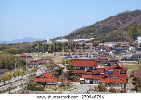 HIROSHIMA, JAPAN - CIRCA APRIL, 2013: Provincial town with traditional architecture is in Hiroshima prefecture, the view from the train window