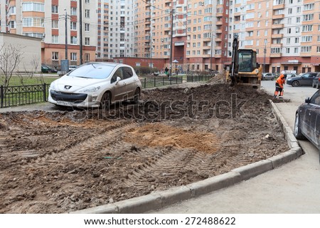 ST. PETERSBURG, RUSSIA - CIRCA APR, 2015: Wrong parking vehicle stands on lawn while construction machinery works for extension of parking area of apartment building. Creation of living environment