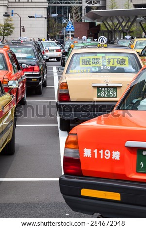 TOKYO, JAPAN - CIRCA APR, 2013: Color taxicabs wait passengers on the parking area near the Tokyo underground station. Public transport is in center of the city