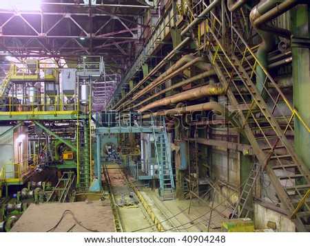 Cold rolling department in ferrous metallurgy factory with hardware under roof and forming rolls.