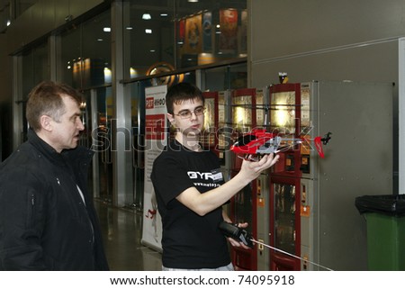 MOSCOW - MARCH 16: Man shows Mini RC helicopter toy presented at the International Toy Specialized Exhibition March 16, 2011 in Moscow