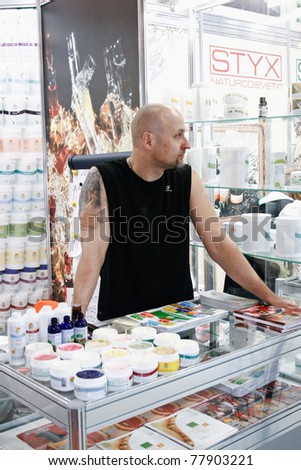 MOSCOW - APRIL 14: Unidentified man sells cosmetics at the international exhibition of professional cosmetics and beauty salon equipment INTERCHARM on April 14, 2011 in Moscow