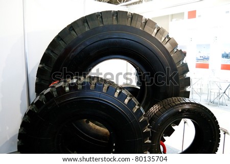 MOSCOW - APRIL 13: Three different tires at the international exhibition of  the Mining and Processing of Metals and Minerals, MiningWorld on April 13, 2011 in Moscow