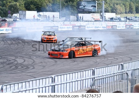 MOSCOW - AUGUST 25: Drift show Orange team at the international exhibition of  the auto and components industry, Interauto on August 25, 2011 in Moscow