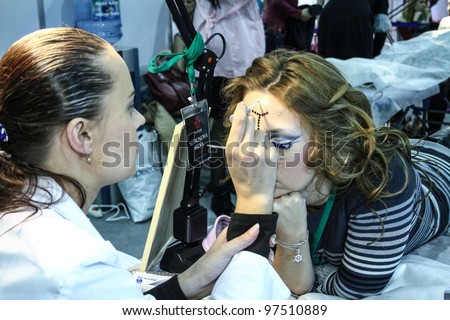 MOSCOW - OCTOBER 26: Body painting in process at the international exhibition of professional cosmetics and beauty salon equipment INTERCHARM on October 26, 2011 in Moscow