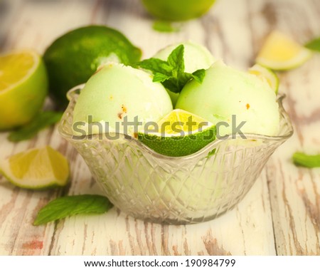 Ice cream lime on wodeen table with fruits.