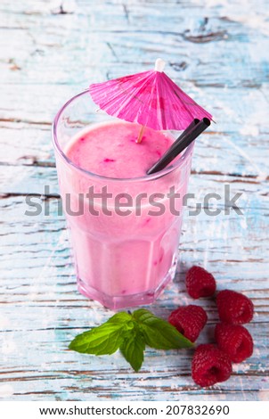 Fresh milk, strawberry, on wooden table, assorted protein cocktails with fresh fruits. Natural background.