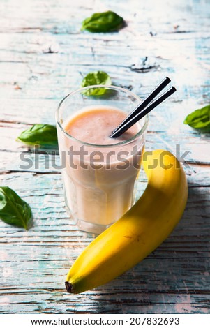 Fresh milk, banana on wooden table, assorted protein cocktails with fresh fruits. Natural background.