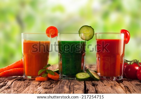 fresh juice, mix vegetable, carrot, tomato and cucumber drinks with nature green background