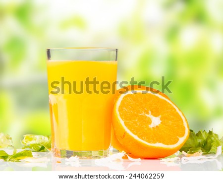 Fresh orange juice, mix fruits, orange drink with nature green background