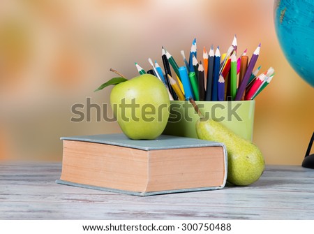 Globe, apple and pencils on wooden table. Back to school concept.