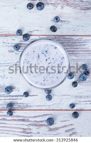 Fresh milk, blueberry drink on wooden table, assorted protein cocktails with fresh fruits. Natural background.