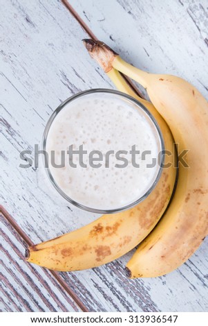 Fresh milk,  banana drink on wodeen table, assorted protein cocktail with fresh fruits.