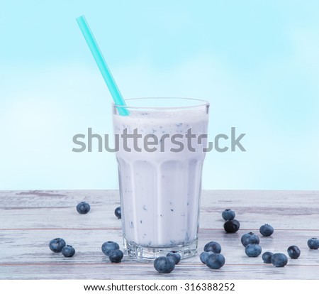 Fresh milk, blueberry drink on wooden table, assorted protein cocktail with fresh fruits.